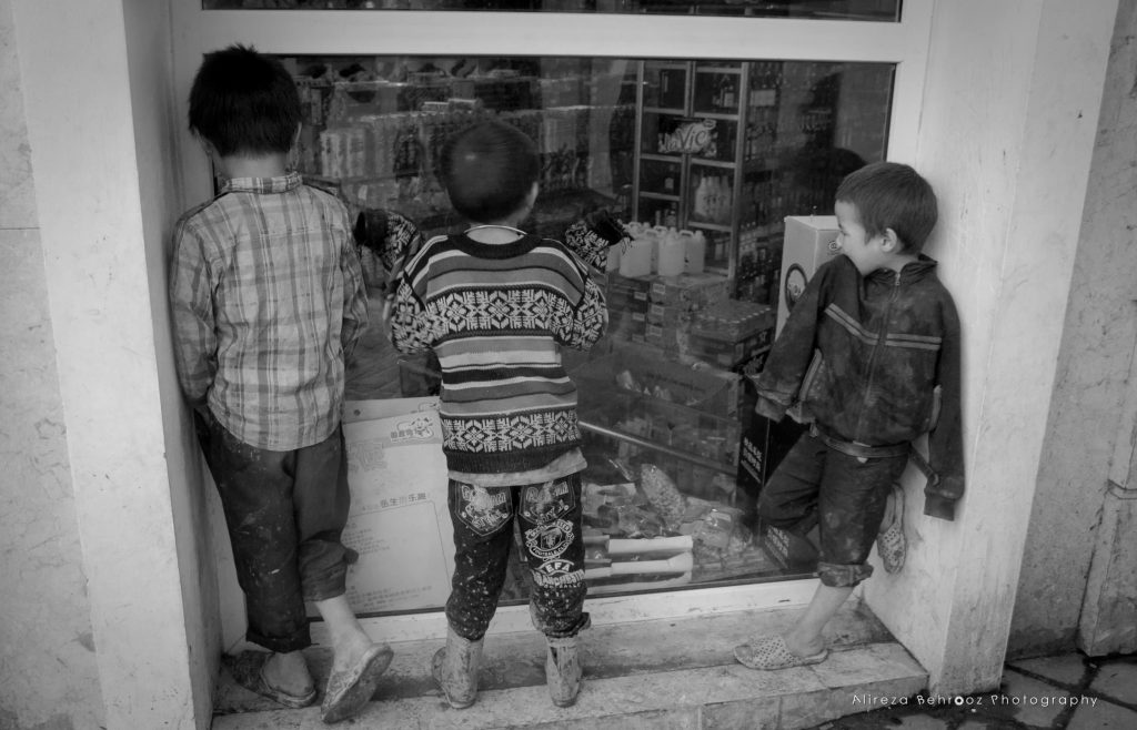 Kids watching the supermarket toys from the window! :(