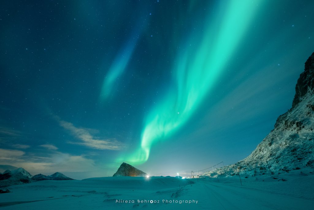 Aurora borealis over Offersøykammen mountain near Napp, Lofoten